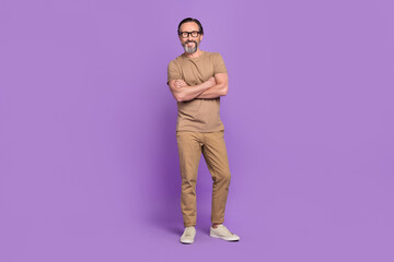 Full length photo of aged man crossed hands wear modern outfit isolated over violet color background