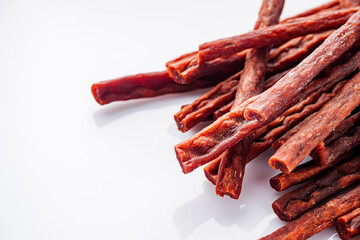 dried fish beer snack on a white acrylic background