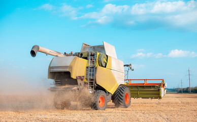 Combine in the field harvests wheat. Export and import of wheat. World food crisis.