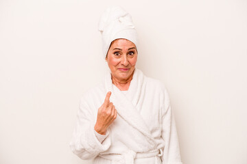 Middle age caucasian woman wearing a bathrobe isolated on white background pointing with finger at you as if inviting come closer.