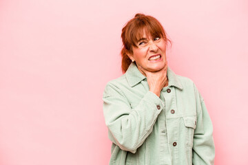 Middle age caucasian woman isolated on pink background touching back of head, thinking and making a choice.