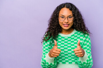 Young hispanic woman isolated on purple background smiling and raising thumb up