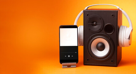 White headphones on speaker and smartphone, music online concept, mockup, isolate