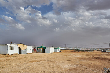 Obraz na płótnie Canvas Syrian refugees lives in quite precarious barracks in Zaatari refugee camp, in Jordan, close to the Syrian border