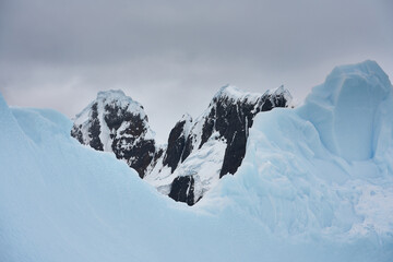 Antartica scenary beautifully combining mountains with sea and icebergs
