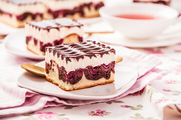 German cake Donauwelle (Danube waves) - vanilla and chocolate sponge cake with sour cherries, vanilla buttercream and chocolate icing