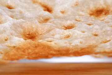 Tradition bread  lavash on wooden background, macro. Shallow depth of field