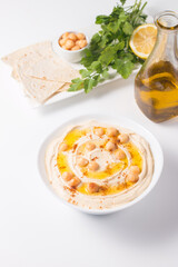 Hummus in a plate with chickpeas, smoked paprika, olive oil and pita. Vegetarian food.