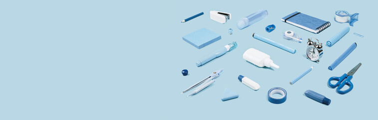 Assorted office and school white and blue stationery knolling background as border. Organized with...