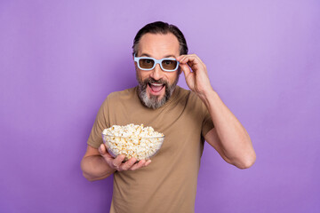 Photo of astonished man in 3d glasses watching comedy film laughing having fun isolated on purple...