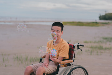 Blur of young man with disability playing bubble shooter toy gun.A practice of using hand and...