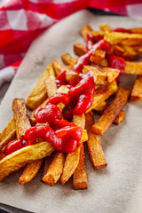 golden french fries on a white wooden rustic background