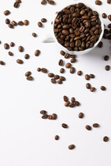 Image of pill of a coffee beans and cup of coffee beans on white background