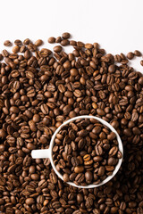 Image of pill of a coffee beans and cup of coffee beans on white background