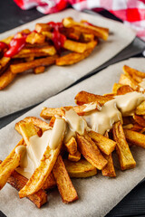 golden french fries on a black rustic wooden background