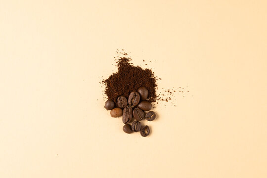 Image of pile of coffee beans and powder over white background