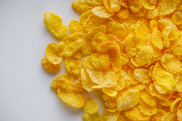 crispy golden cornflakes on a white acrylic background