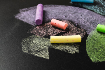 Composition of colorful pastels on black surface with copy space