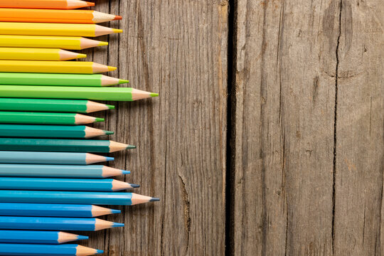Composition of colorful crayons on wooden background