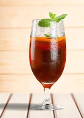 Iced fruit cocktail or cold drink and mint leaf. Refreshing summer drink.