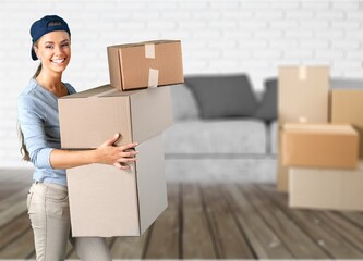 Affectionate young person in house among cardboard boxes on moving day, relocating to new property