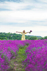 Beautiful woman in lavender field. Selective focus.