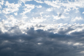 Blurred image of the sky half heavily covered with clouds.
