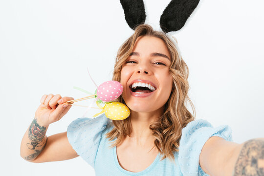 Pretty young woman wearing Easter bunny ears