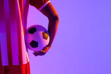 African american male soccer player with football over neon pink lighting © vectorfusionart