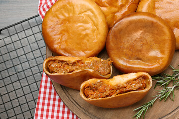 Delicious baked patties with cabbage on wooden table, top view