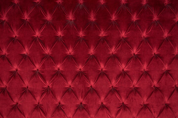 Quilted velour buttoned burgundy red color fabric wall pattern background. Elegant vintage luxury...