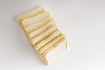 Fototapeta na wymiar Loaf of sliced white bread isolated on white background