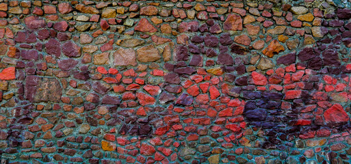 Abstract background of a wall with multicolored stones.
