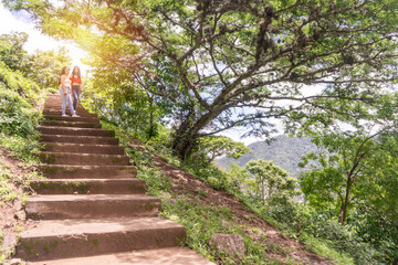 Two teenage women at the top of the stairs in a mountainous area of Nicaragua