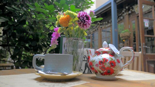 A photo of a tea service in a garden
