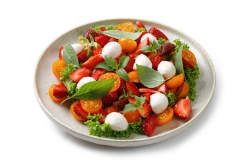Fresh salad with strawberry, tomatoes cherry, mozzarella cheese and basil in ceramic Plate isolated on white background. Healthy bright salad.
