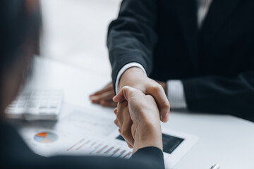 Close-up two business men holding hands, Two businessmen are agreeing on business together and...