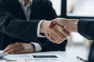 Close-up two business men holding hands, Two businessmen are agreeing on business together and...