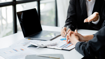 The sales department is having a monthly summary meeting to bring it to the department manager, they are verifying the correctness of the documents that are prepared before bringing in to the manager