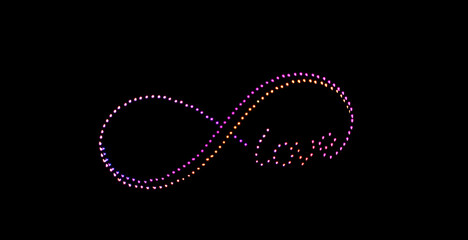 infinity symbol and the word love created by drones on the night sky