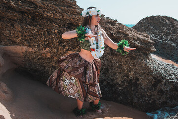 Hula dancer on the beach. Woman in bikini dancing Hawaiian typical of Tahiti. Tropical lady at...