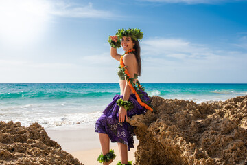 Hula dancer on the beach. Woman in bikini dancing Hawaiian typical of Tahiti. Tropical lady at...