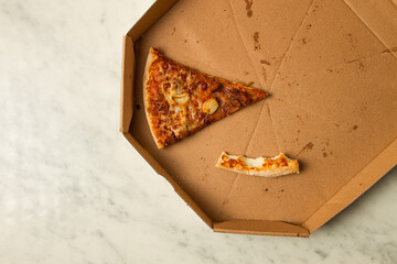 Pizza box, on the table, with one piece and a crust, leftovers, top view, no people,