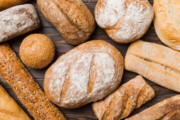 Homemade natural breads. Different kinds of fresh bread as background, top view with copy space