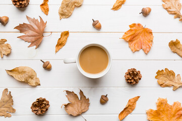 Cup of cocoa with autumn leaves abstract still life top view vith copy space