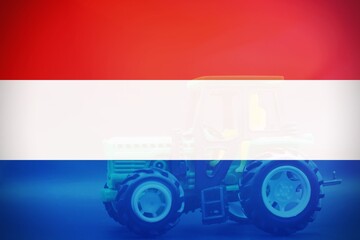 Dutch flag with a tractor as background, concept of farmer protest.