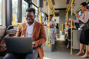 African american man working while commuting
