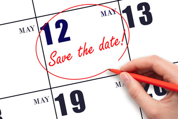 Hand drawing red line and writing the text Save the date on calendar date May 12.