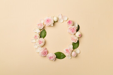 Flat lay with rose flowers on color background, top view