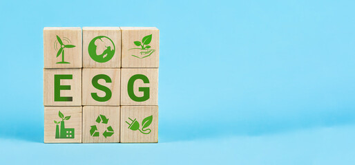 ESG Words on a wood cubes. ESG concept of environmental, social and governance. Wooden cube with...